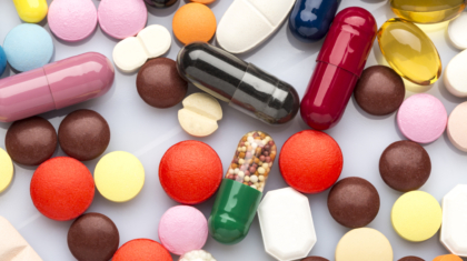 Scattered colorful medical pills and capsules