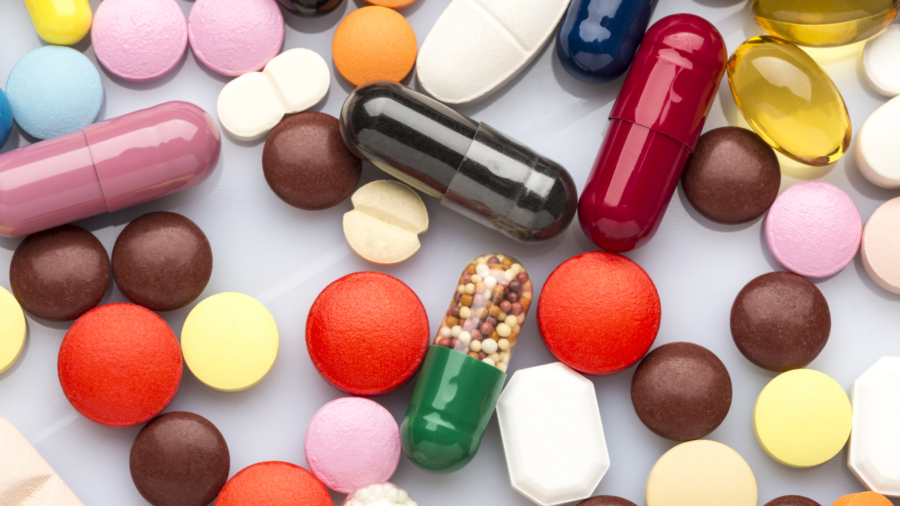 Scattered colorful medical pills and capsules