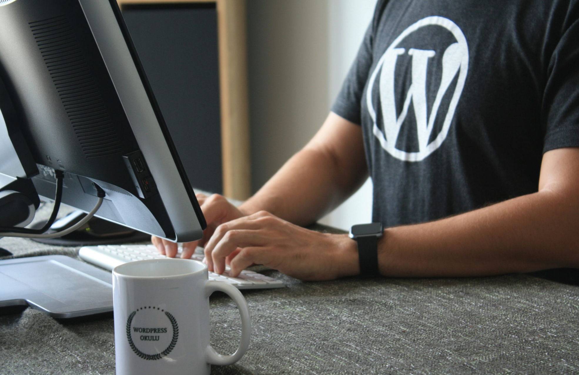 person in black and white t-shirt using computer